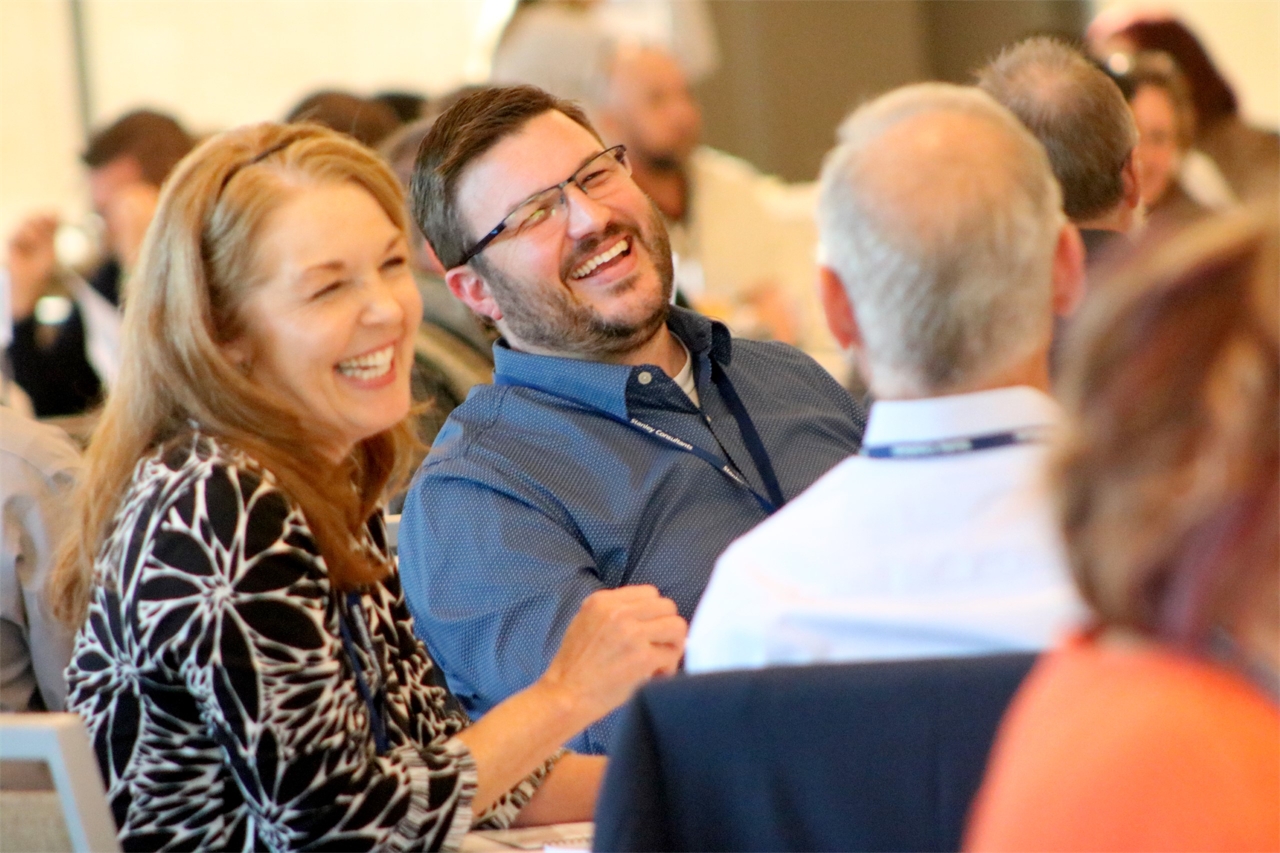 Leaders gathering face-to-face for a leadership training session.