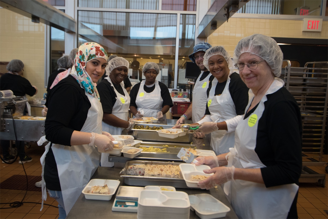 Feed More Community Kitchen meal packaging volunteers.jpg