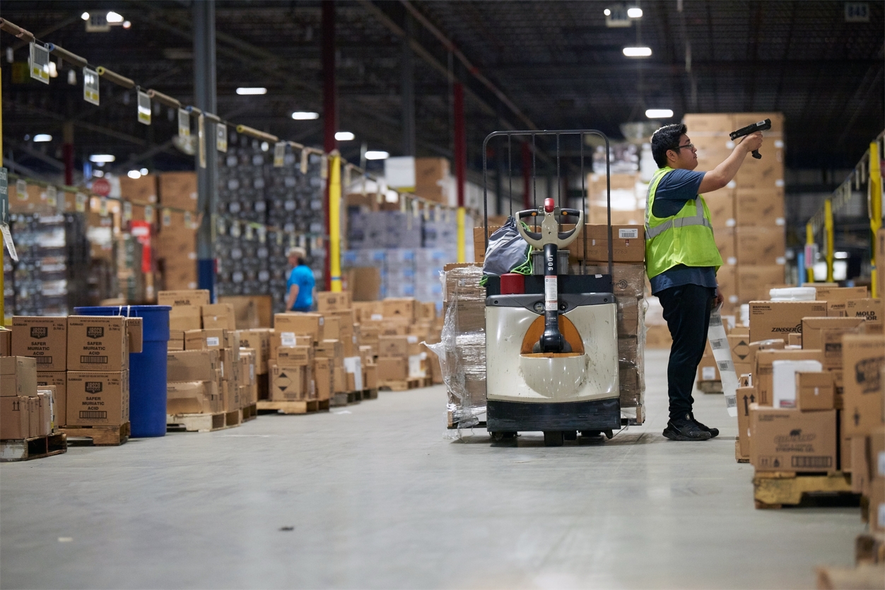 A supply chain associate working in a Lowe's distribution center.
