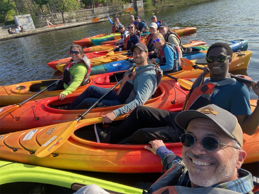 People participating in our wellness initiatives like to get outdoors - including kayaking on the Charles River!