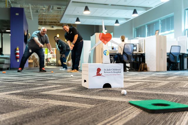 Employees in a putt putt challenge to raise money for St. Jude during a national fundraising event.
