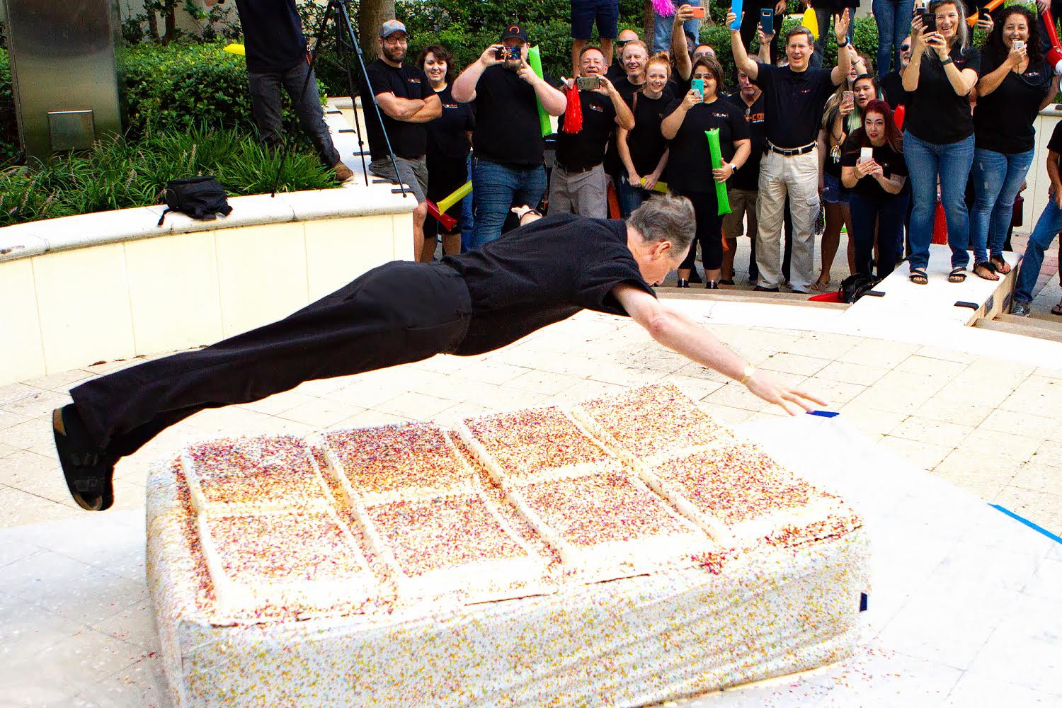 Stu dives into a giant cake for KnowBe4's 8th birthday