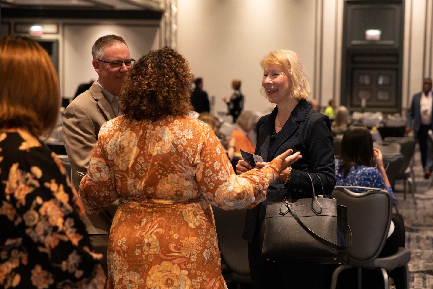 Executive Director & Partnerships Team Chatting at Conference