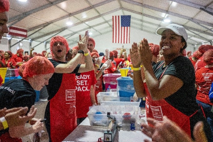 AARP staff volunteer at AARP Foundation’s annual Celebration of Service Meal Pack Challenge on the National Mall.