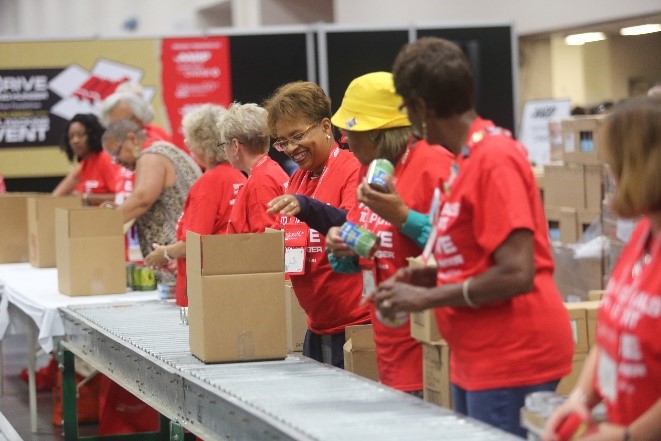 AARP staff volunteer at AARP Foundation’s annual Celebration of Service Meal Pack Challenge on the National Mall.