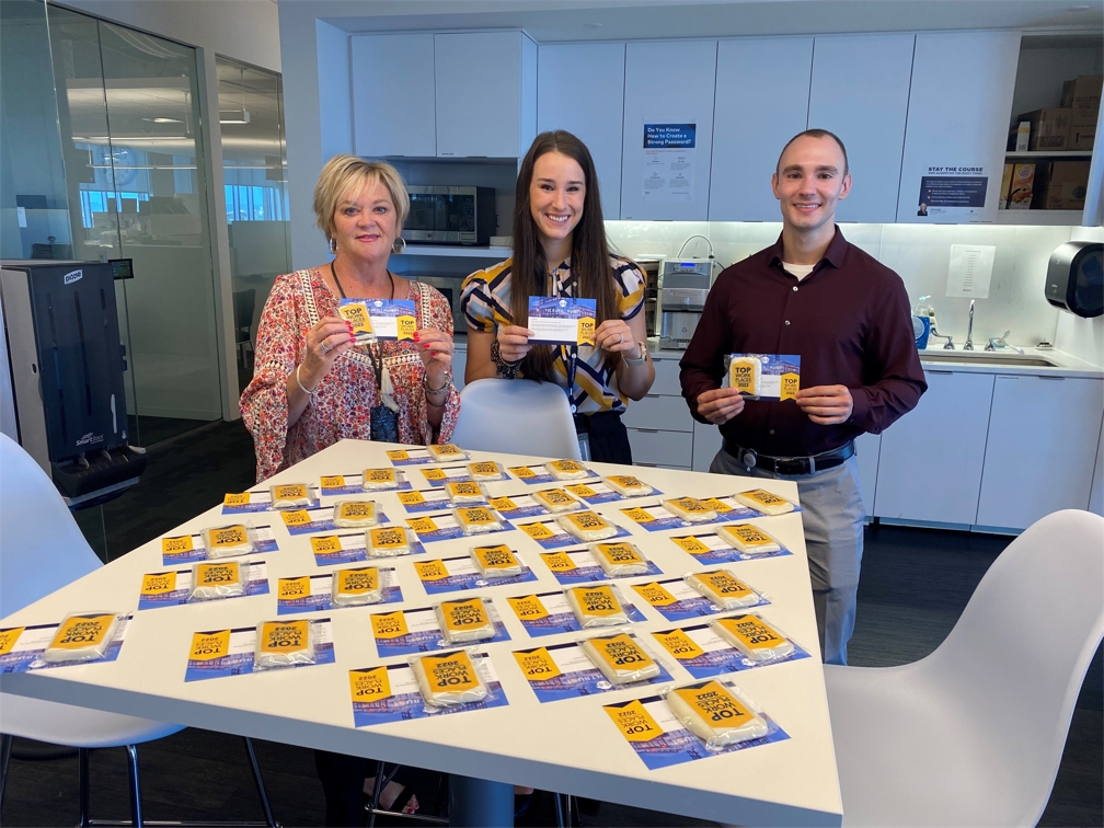 Colleagues celebrate HealthTrust's win as a 2022 Top Workplace in Middle Tennessee with cookies and coffee.