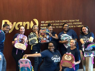 Atlanta members spend some time together packing backpacks to donate to school children.