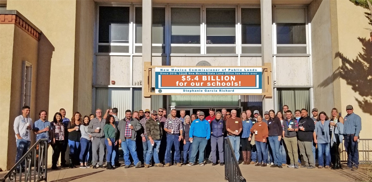 NMSLO Staff with new banner.jpg