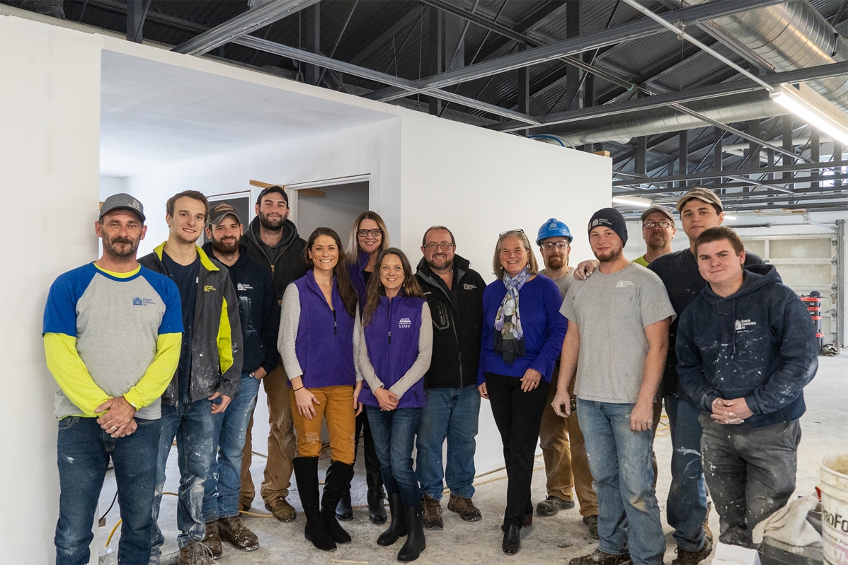 Our Remodeling Division crew with the team from Shelters of Saratoga (in purple), our Remodeling Division Director James Ackerman (center), and former Saratoga Springs City Mayor Meg Kelly (center, in blue) on-site during the 2019 renovation of Code Blue's new temporary shelter in Saratoga Springs.