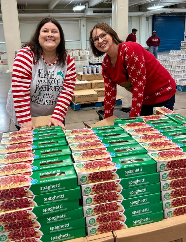 Two associates pack spaghetti into the boxes for The News Sentinel Charities' Empty Stocking Fund.