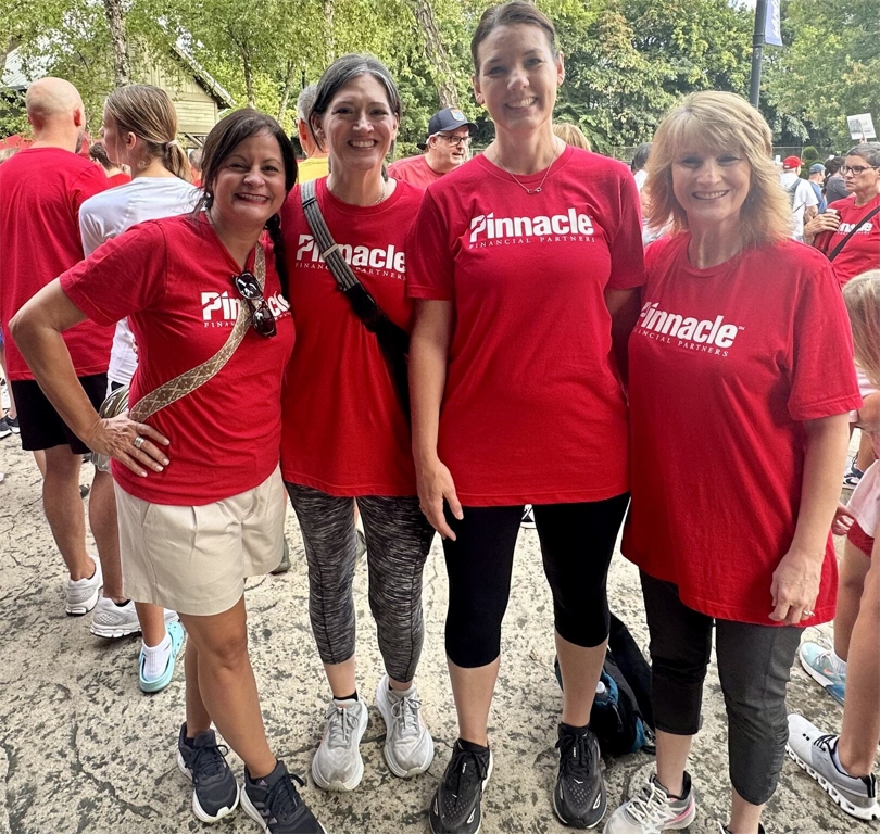 Pinnacle associates have incentives to participate in the firm's wellness programs, receiving discounted premiums for "silver" status based on collecting points and "bucks" for specific activities that improve health. This group participated in the Heart Association's walk to support the nonprofit and get points for the wellness program.