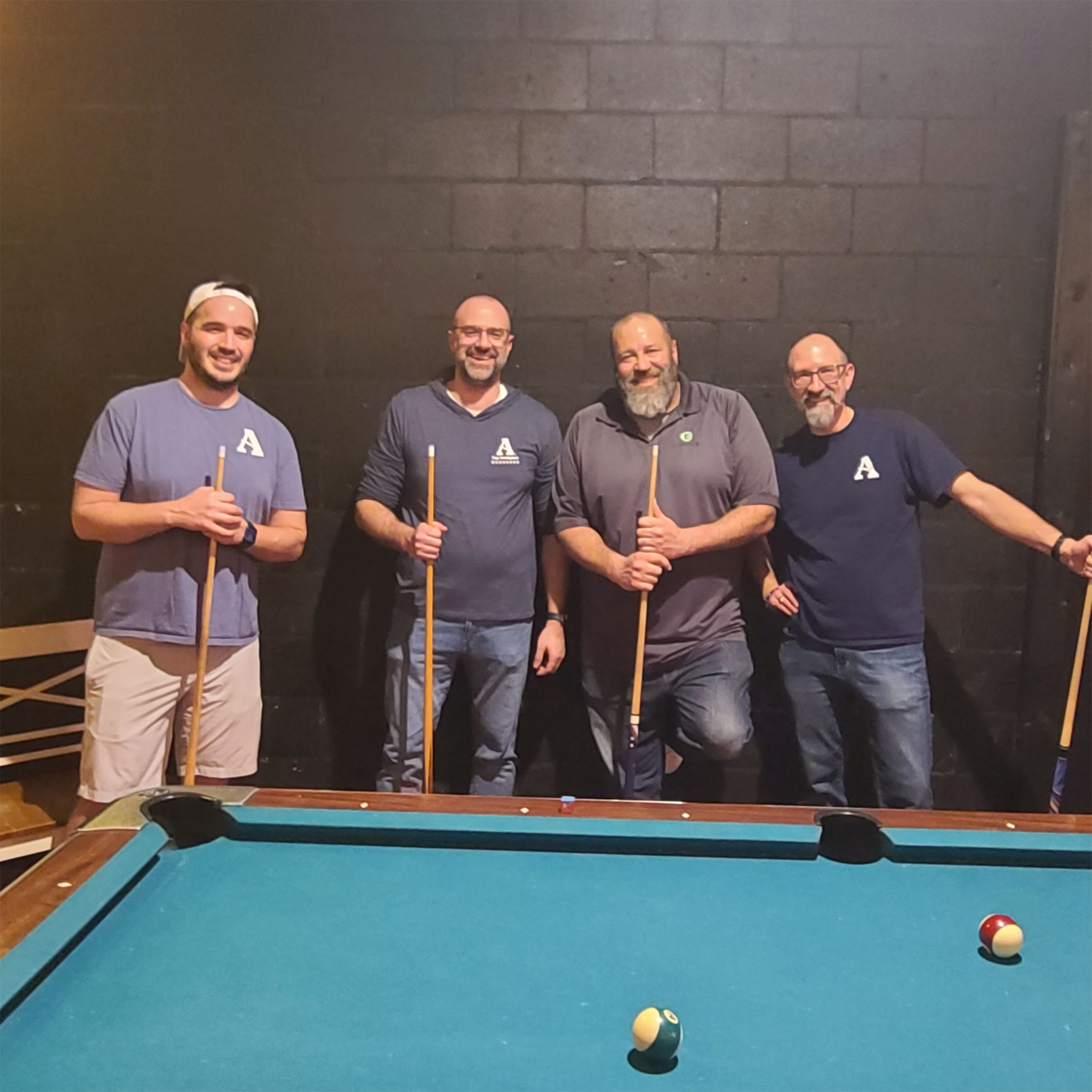 Some of ANR's leadership playing pool at a company party