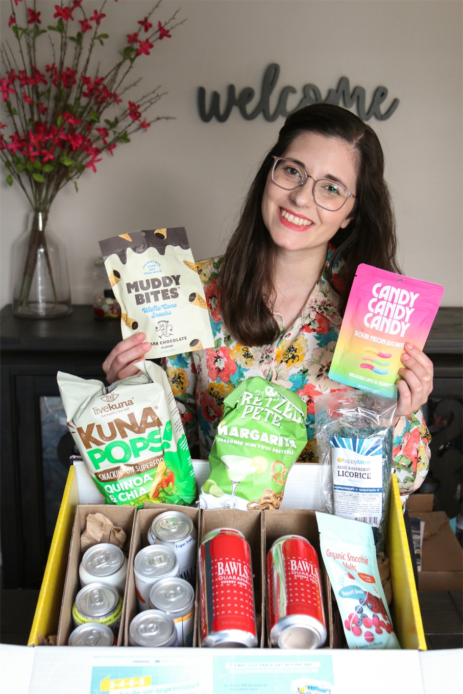 Our colleague poses with her snack box from Colleague Appreciation Month.