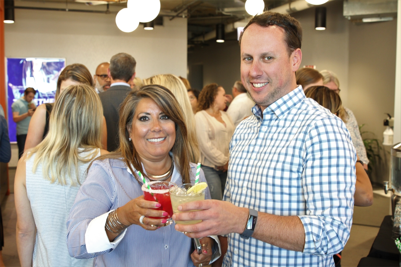 Colleagues celebrate during an in-office margarita party.
