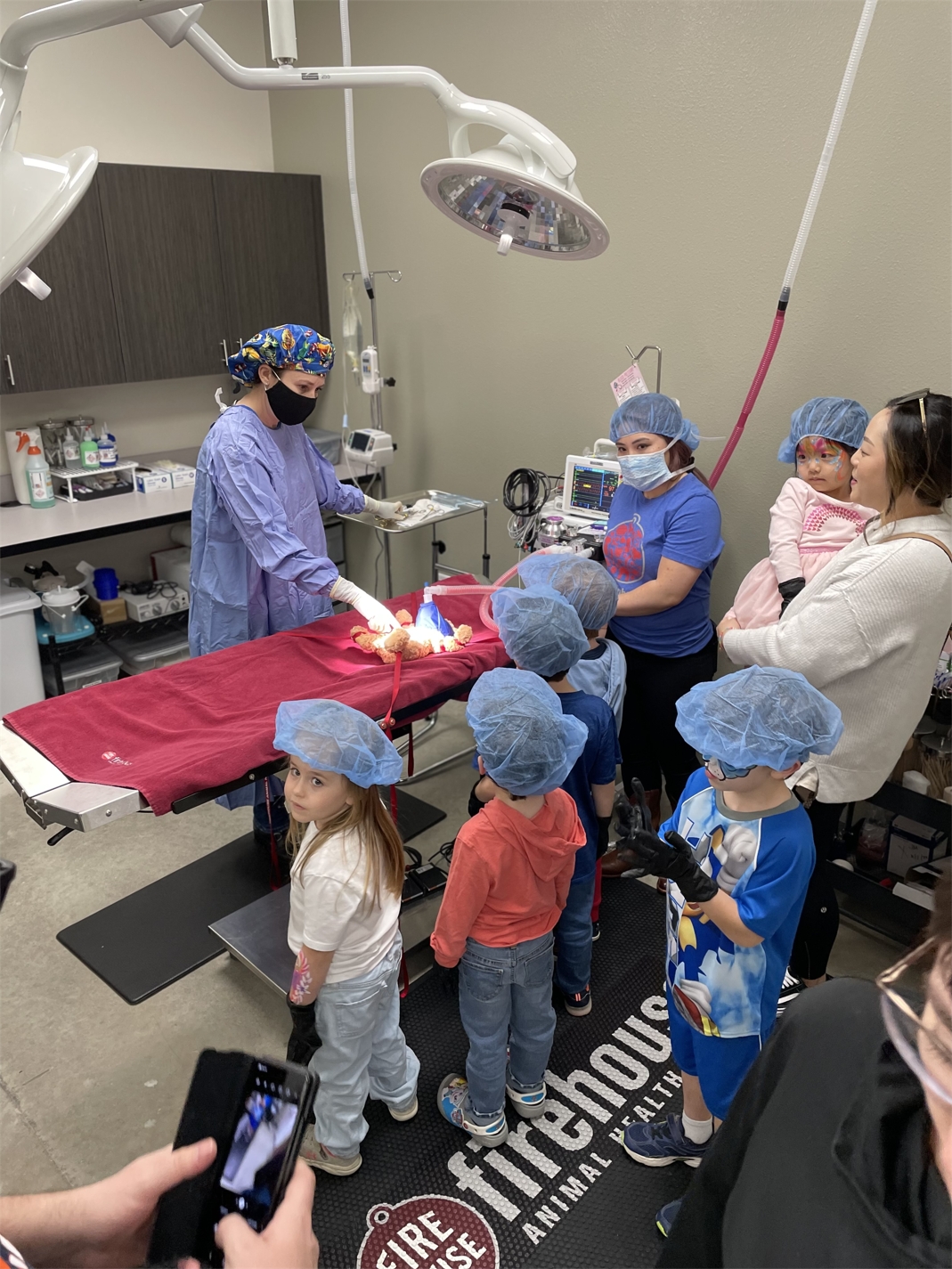 Dr Sherry Hill perfoms a Teddy Bear Surgery at the Firehouse Cedar Park Grand Opening Ceebration - February 2023..jpg