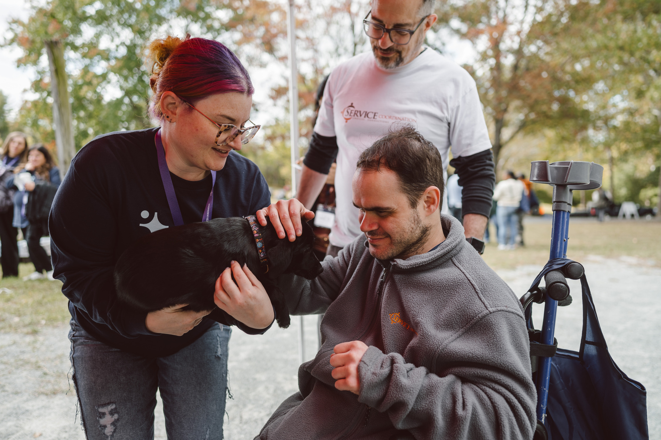 SCI Team Members and Board Members enjoy a visit with friendly puppies during SCI Day.