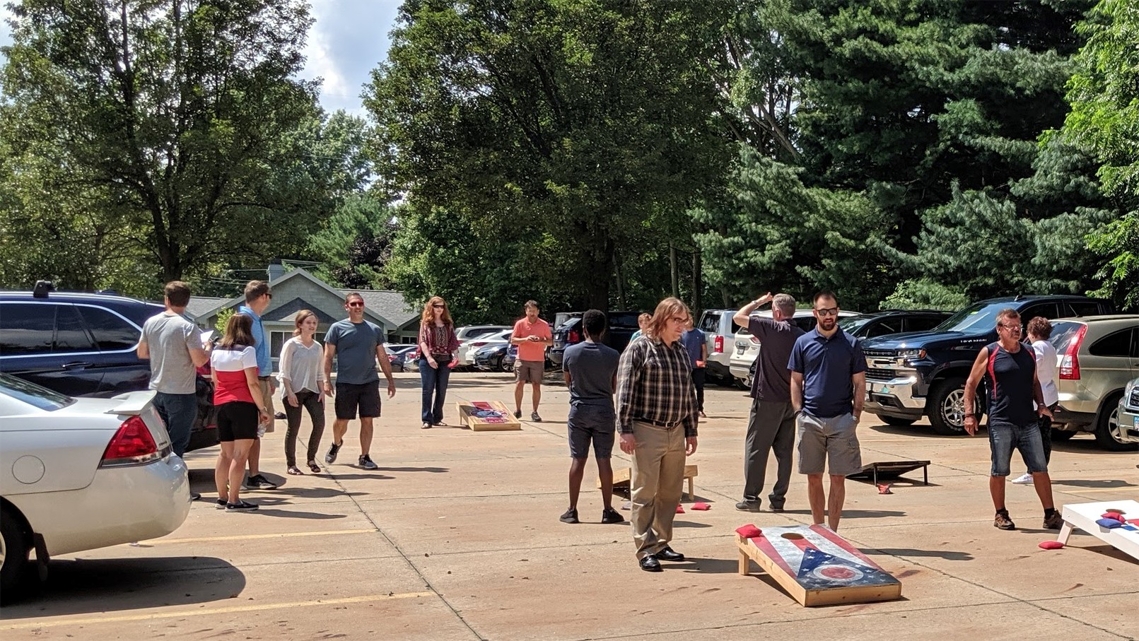 Etactics employees getting ready for the annual cornhole tournament in Summer 2019.