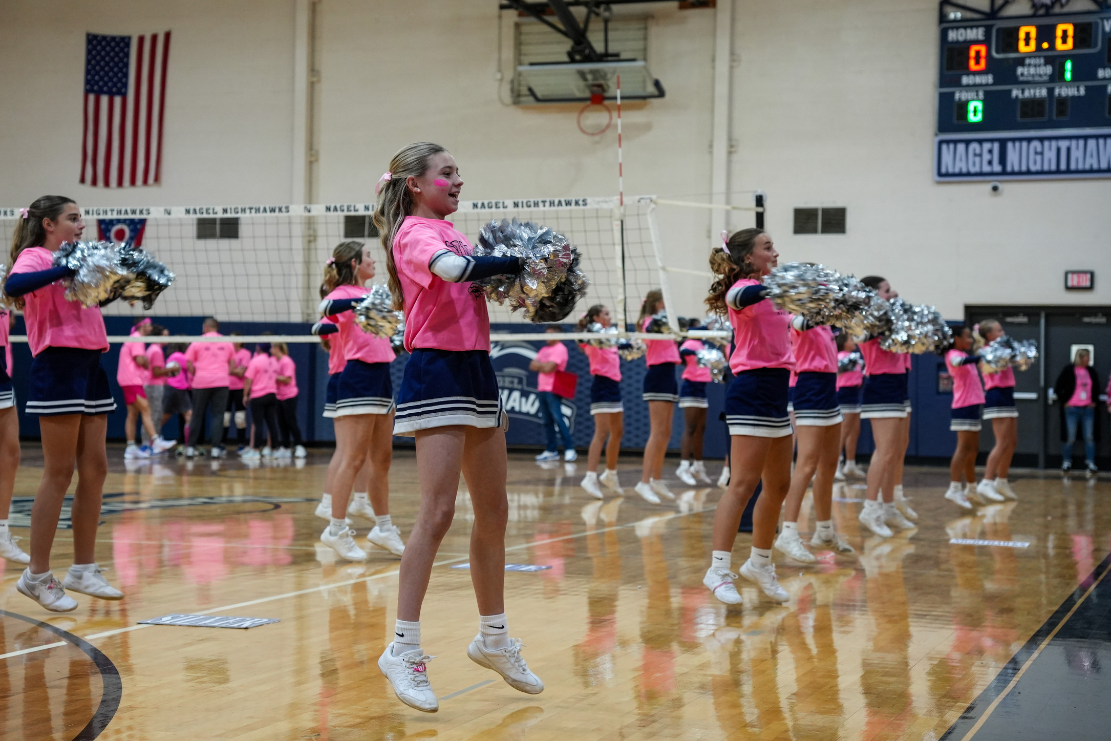 Nagel Middle School cheerleaders get the crowd excited during the Volley for the Cure Pink Out cancer awareness event.