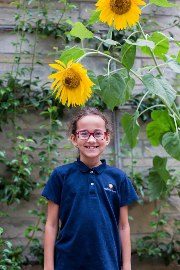 Smiling student with sunflower