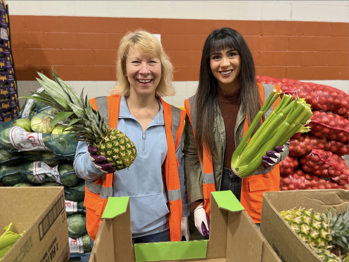 Executive Director Candee Chambers and Recruit Rooster's Sierra Sieracki enjoy volunteering at Gleaners Food Bank