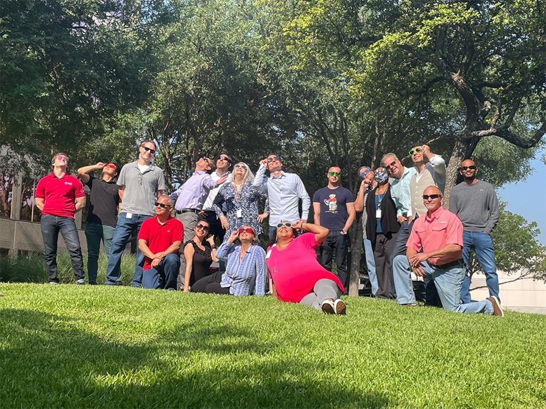 Employees gather outside OCI Solar Power's headquarters for a fun photo shoot during Summer Soltice 2023.