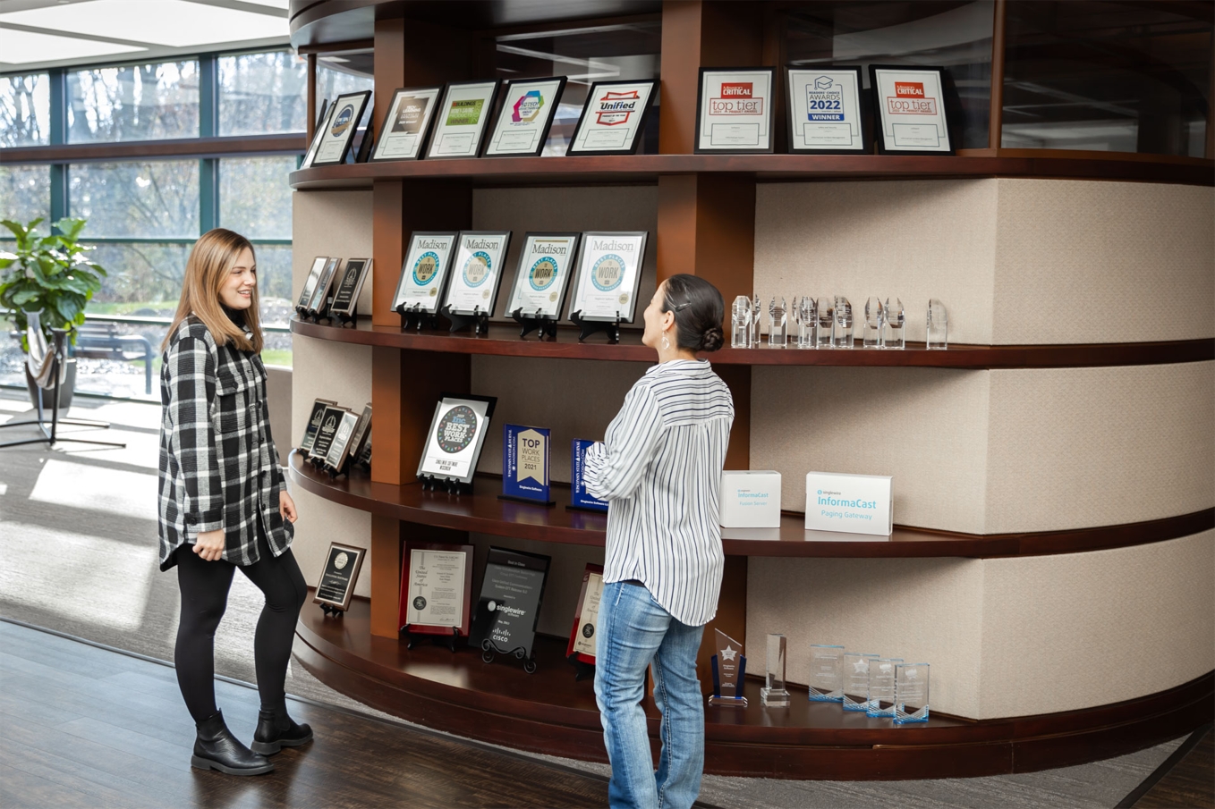 Singlewire team members examine the trophy case