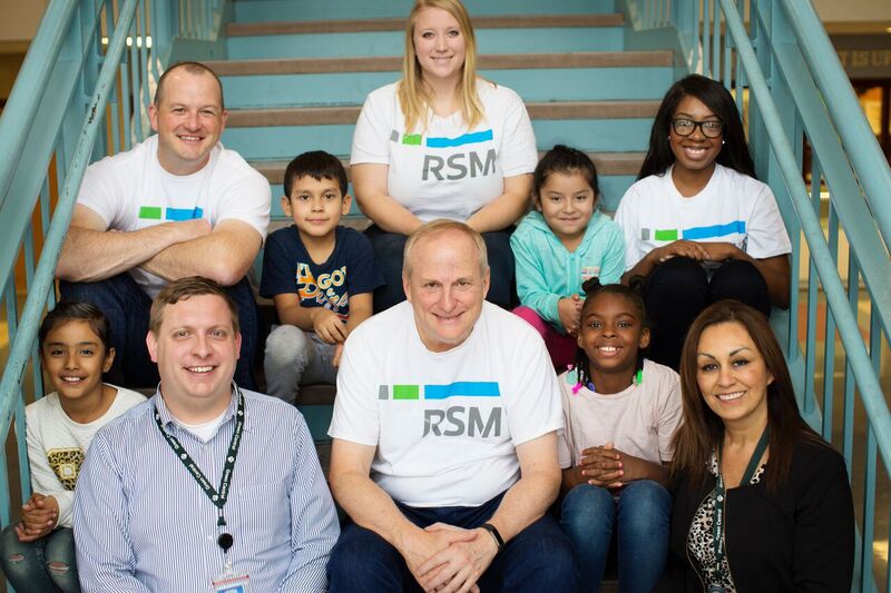 RSM Minneapolis Leaders pose with children on volunteer day