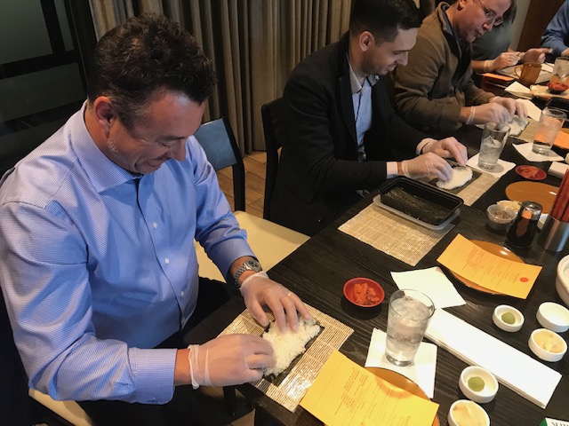 Mike Discenza, CFO - NA joins his team in a sushi-making team-building activity (pre-COVID)