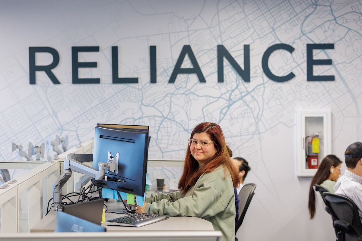 employee smiling at their desk