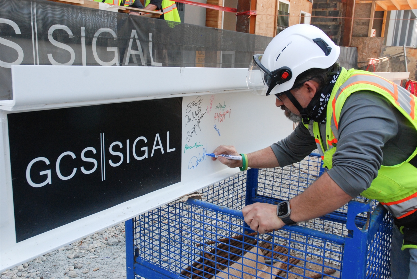Superintendent Signing Beam at The Guardian Apartments Topping Out Ceremony