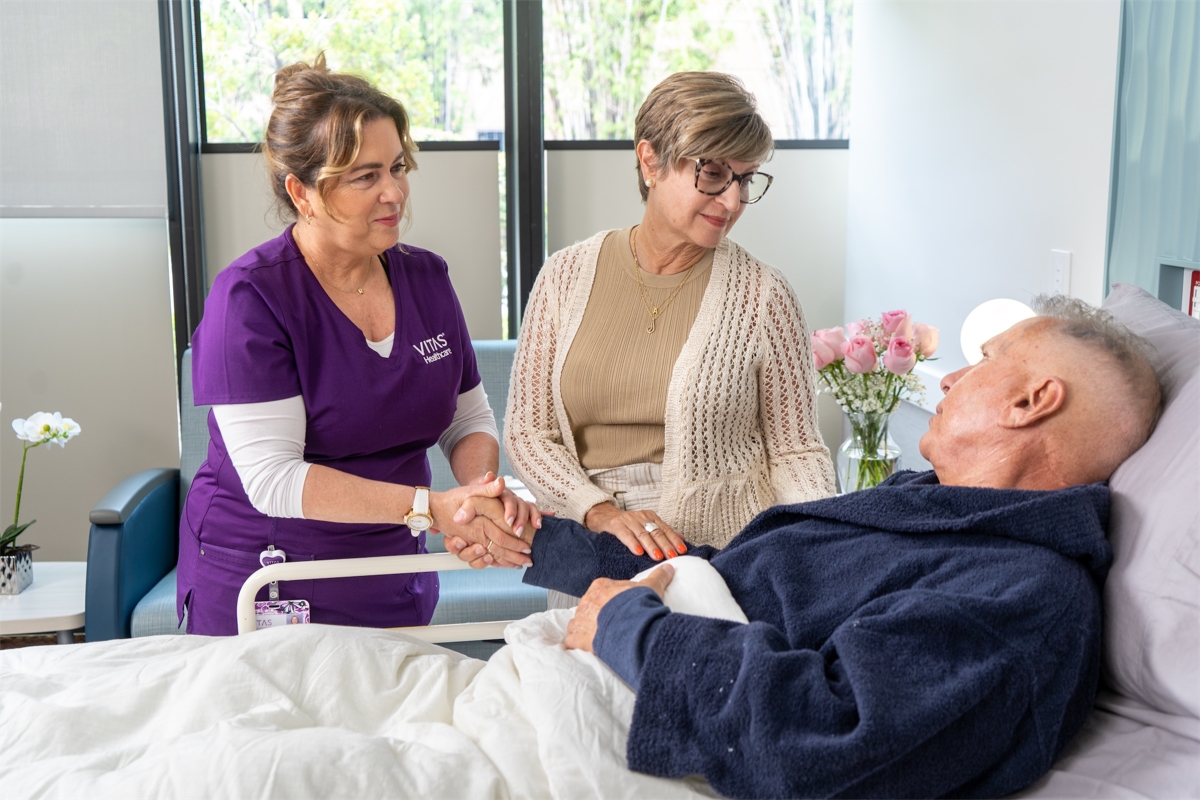VITAS Healthcare Female nurse with male patient and caregiver.jpg