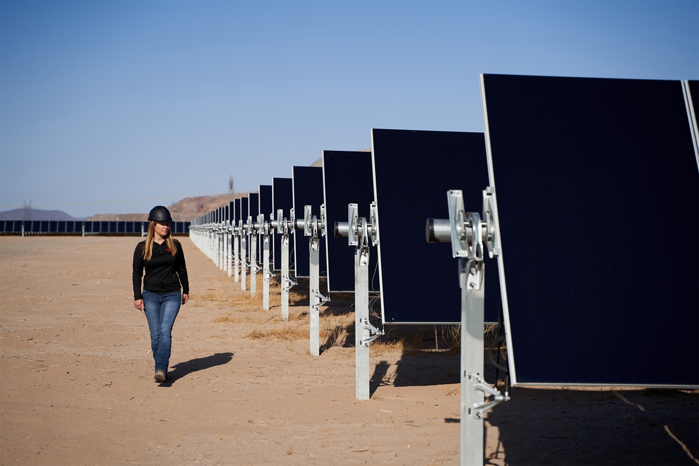 EDPR NA Employees walking along the solar panels at one of our Solar Parks