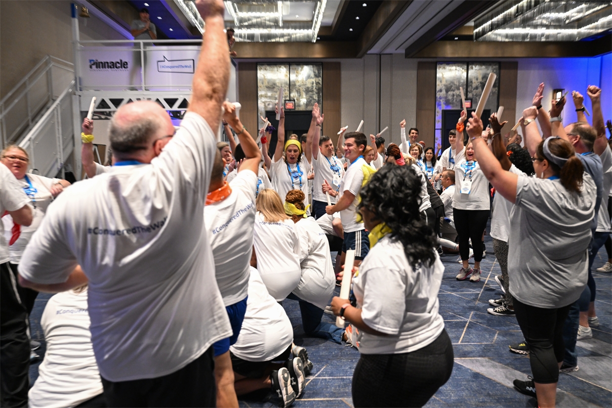 Pinnacle's newest associates celebrate together during teambuilding exercises at a three-day orientation with the CEO, setting the tone for embracing the firm's "win as a team and lose as a team" mentality.