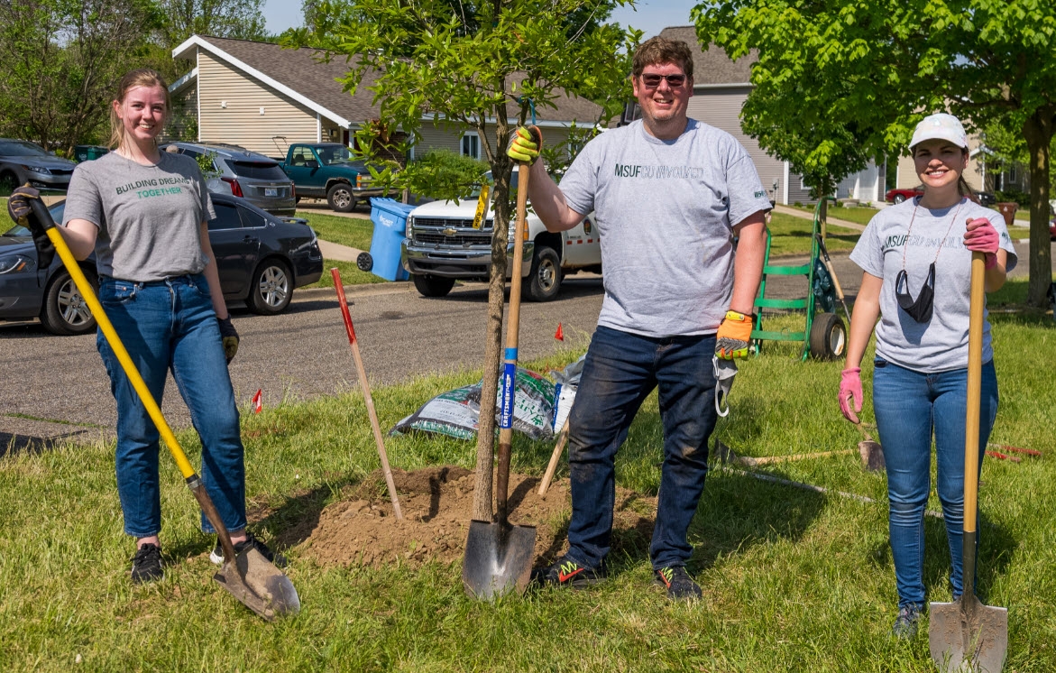 Employees planting trees for Arbor Day.