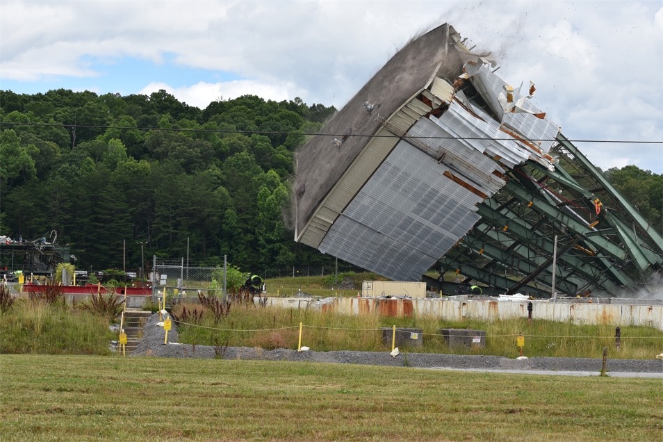 Workers used large winches to tear down a 180-foot tower of the Centrifuge Complex at Oak Ridge.