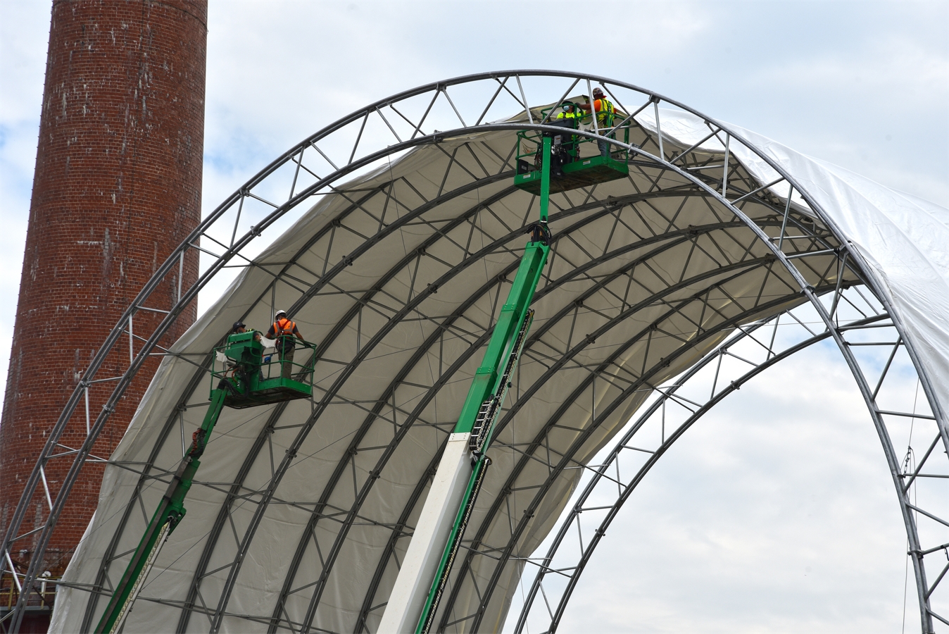 Crews manually added adding 12,000 square feet of fabric to the trusses to complete the cover for the protective tent at the Building 3026 demolition project at Oak Ridge.