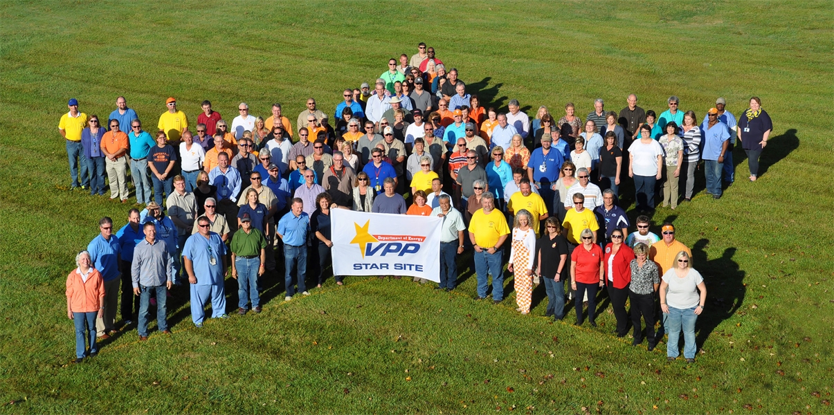 Workers display the sign designating UCOR as a DOE Voluntary Protection Program Star site.