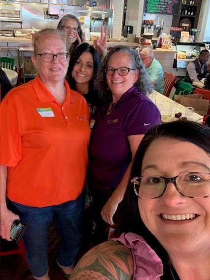 Team members gathered for a networking lunch full of hugs and connections.