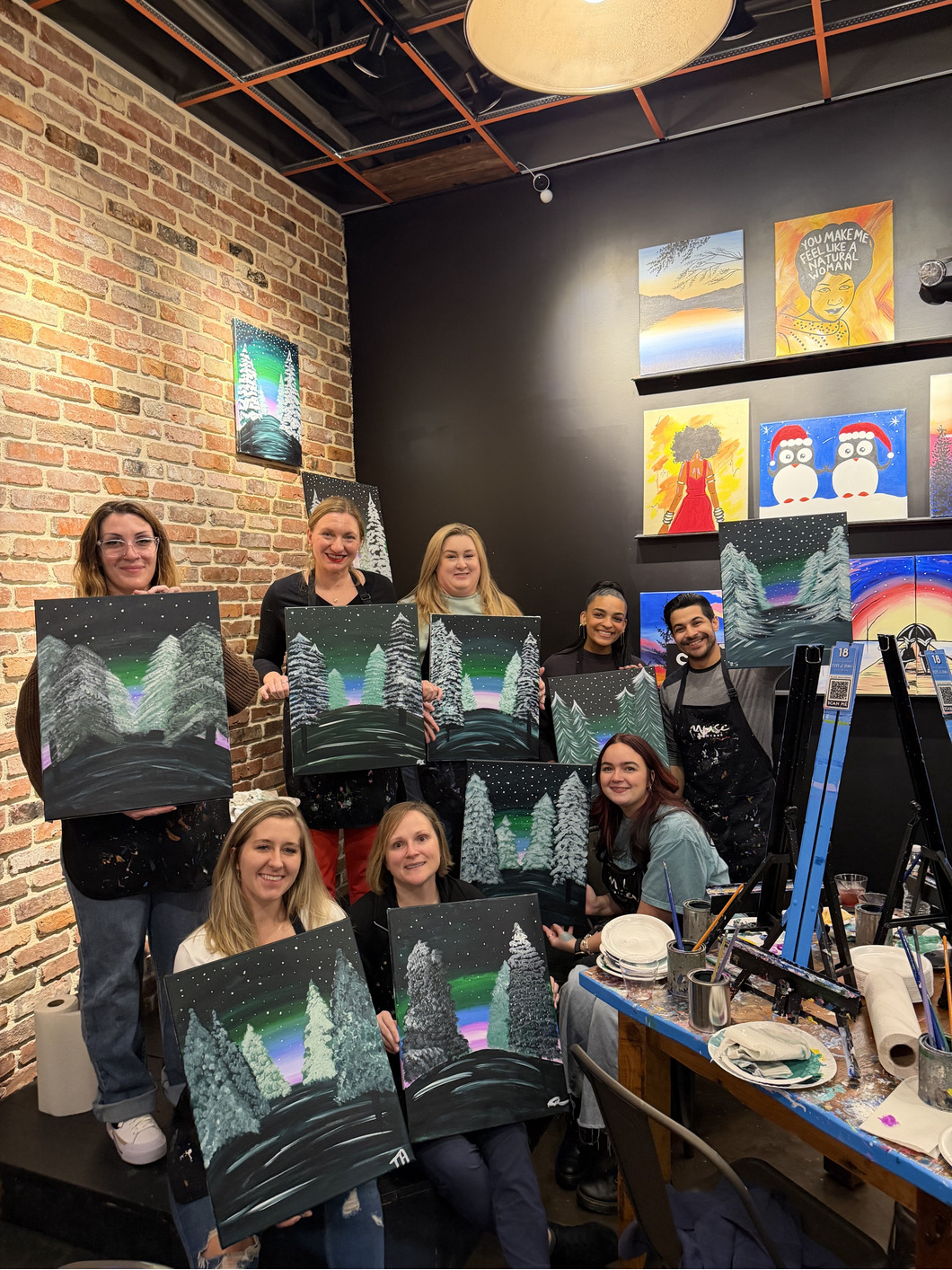 Employees take a paint and sip class together