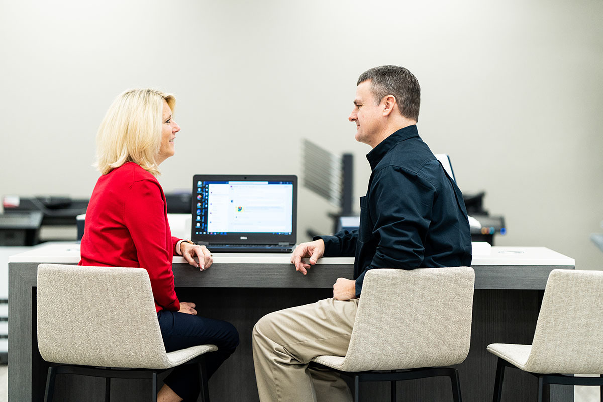 Man and woman discussing at laptop.jpg