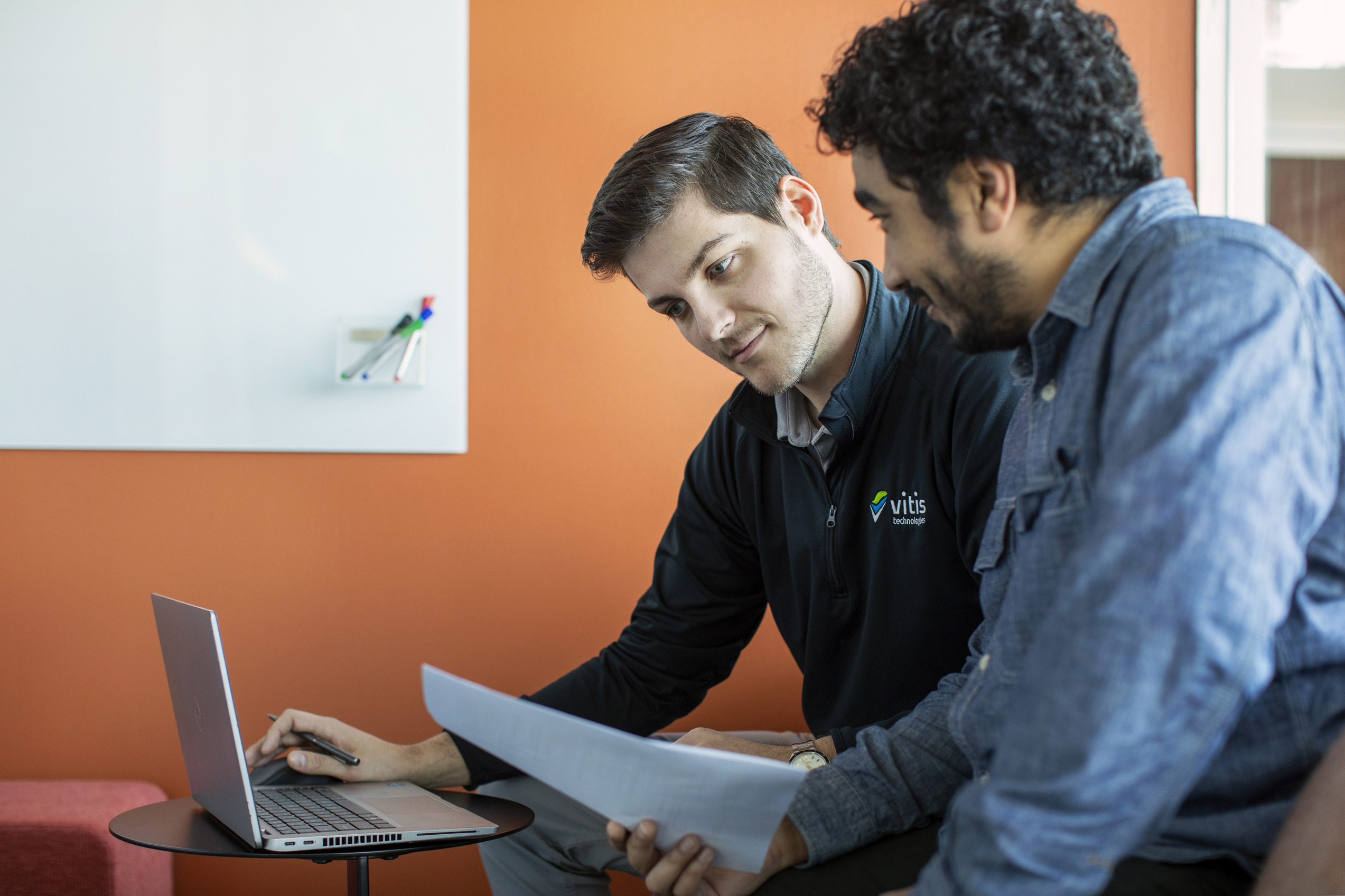Men viewing a laptop together
