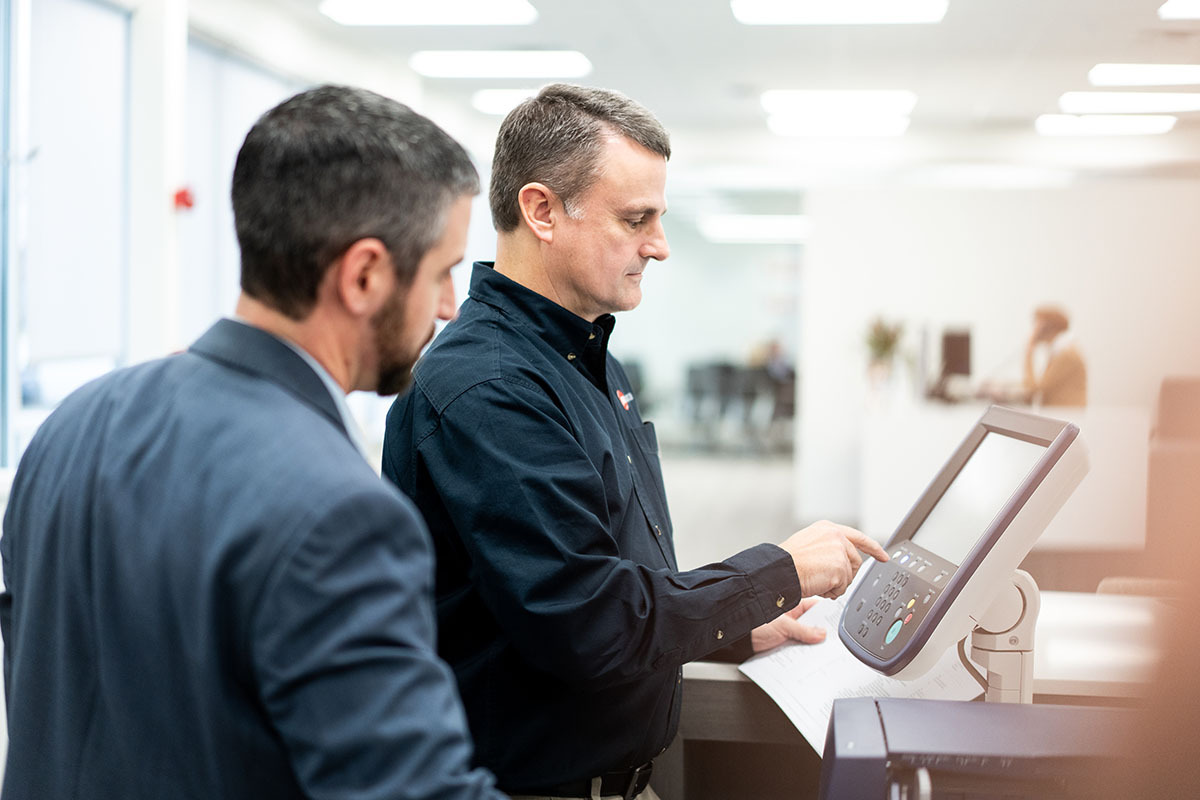 Two men at Printer