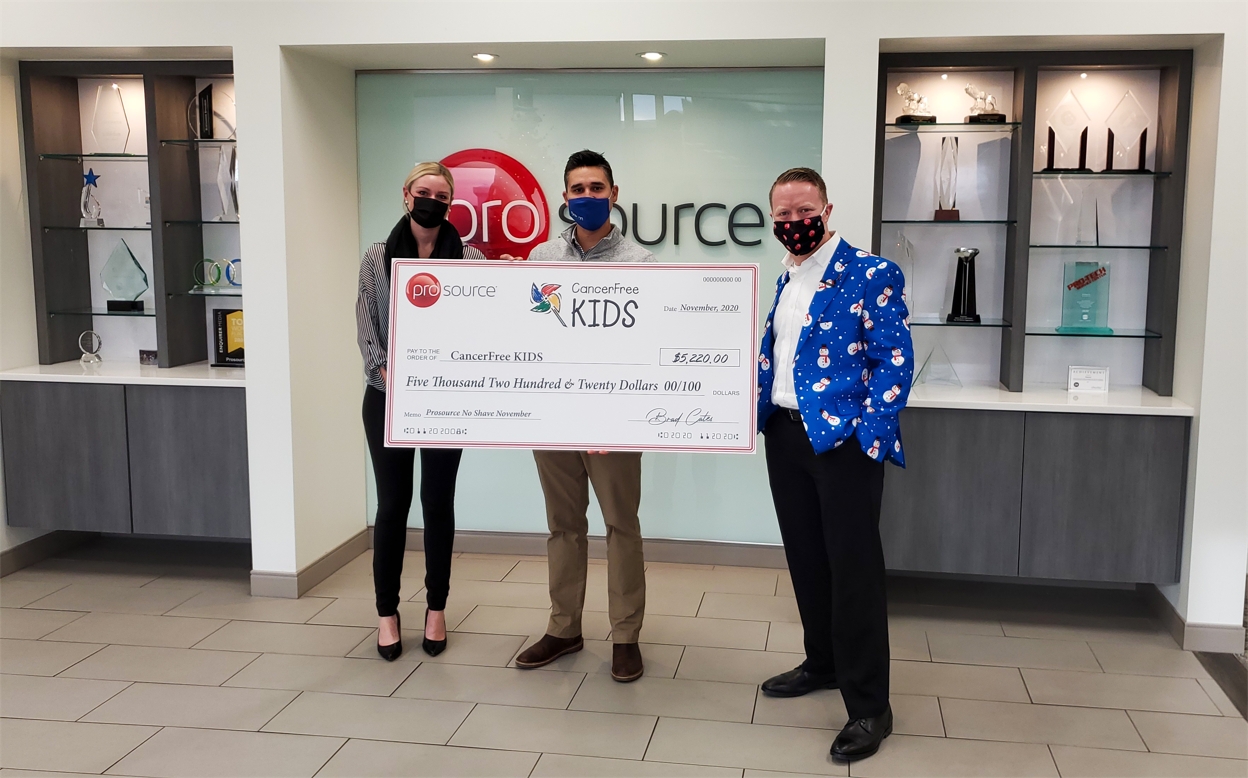 Prosource team members present a fundraising check to CancerFree KIDS,