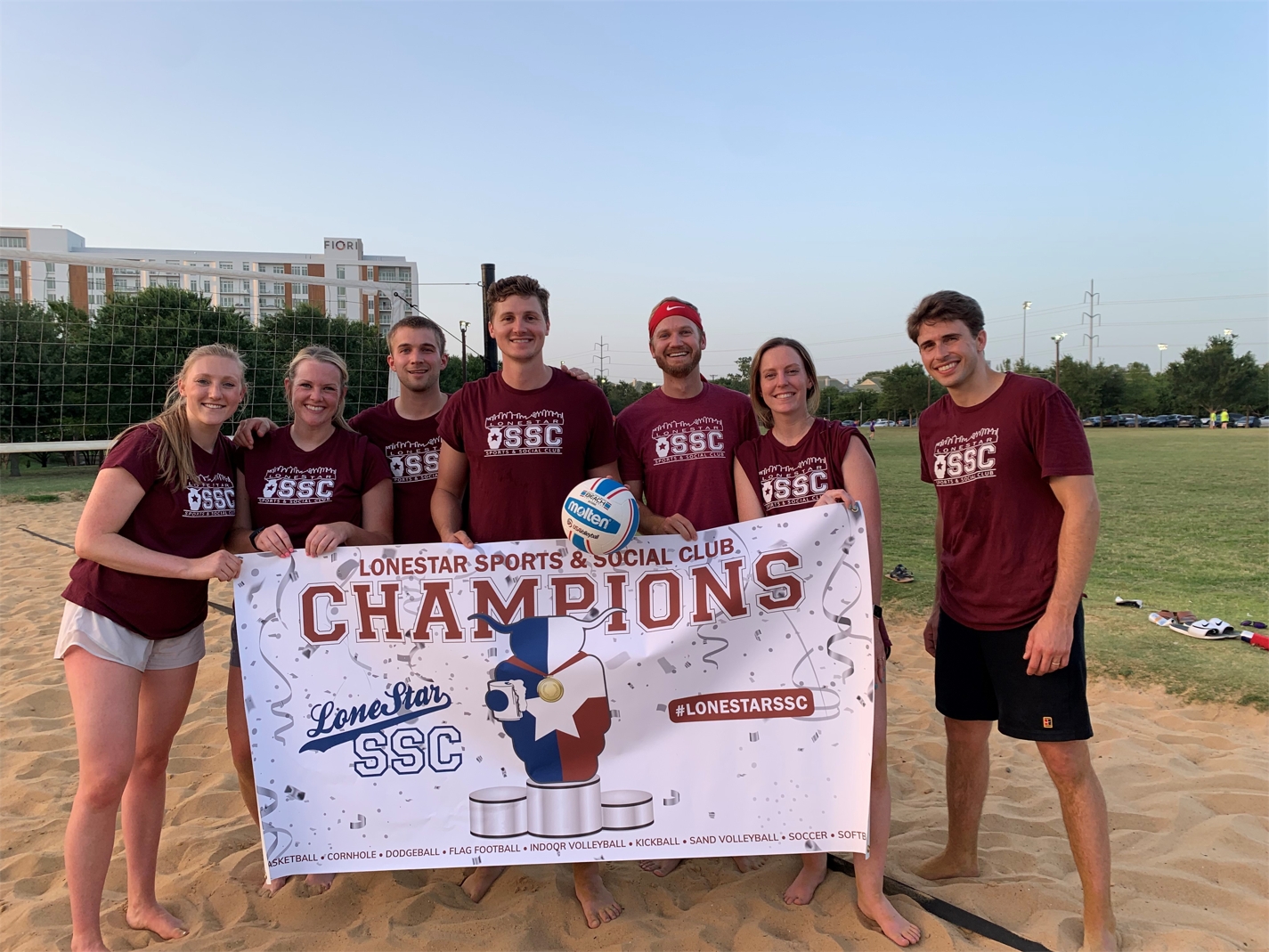 Merit Energy employees celebrate their sand volleyball championship.