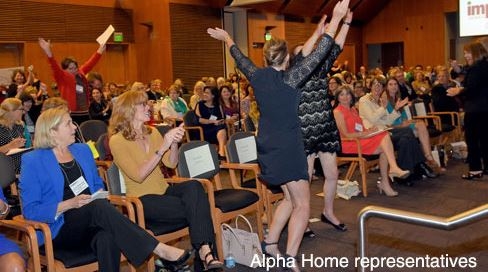 Alpha Home CEO, Angela White, and Alpha Home COO, Nangie Lowrie, react after learning Alpha Home was awarded a $100,000 grant by Impact San Antonio. 
