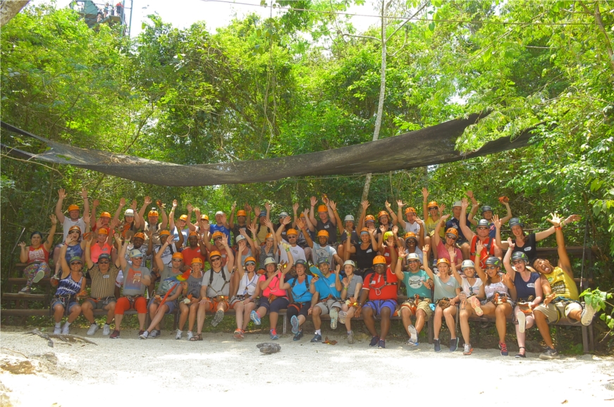 Employees pose for a photo after a zip-line outing at BCD Travel’s Circle of Excellence in Cancun, Mexico, in May 2016. The annual event recognizes and celebrates achievements of employees from around the globe.