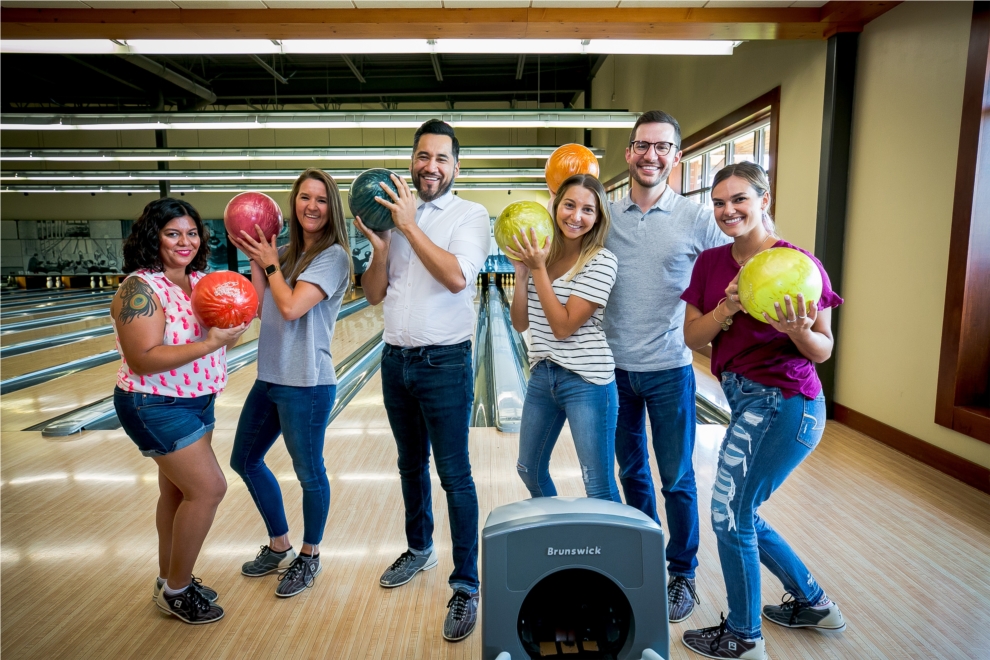 Colleagues show off their bowling -- and posing -- skills during Employee Appreciation Day 2019 at Pinstripes. 