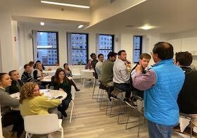 HqO employees attend a wine tasting event during an office happy hour.