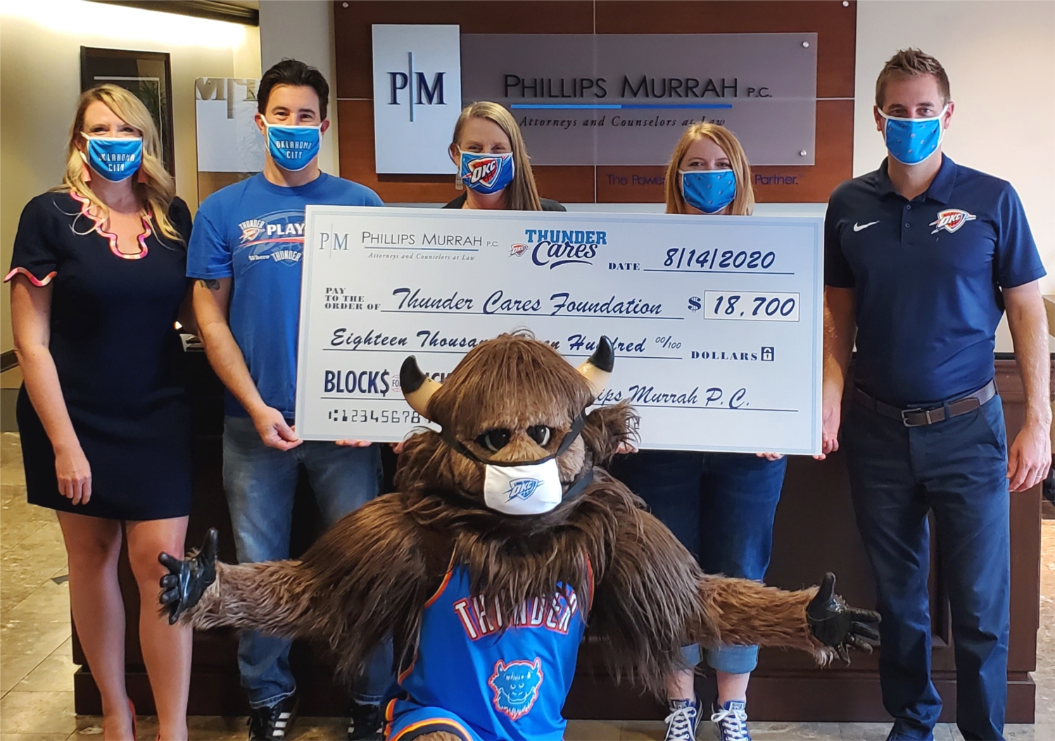 Phillips Murrah presents a check to Thunder Cares Foundation as part of the Firm's partnership with the Oklahoma City Thunder Basketball's Blocks for Bucks campaign.