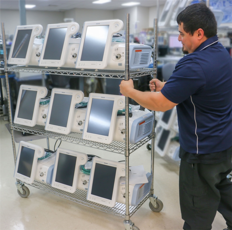 USME employee preparing essential medical equipment for shipment to hospital partners.